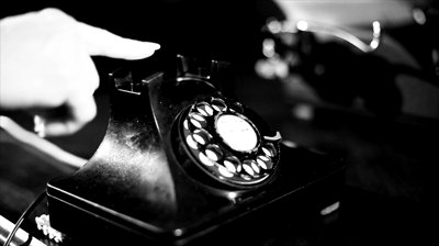 stock-footage-a-woman-picks-up-the-receiver-of-an-old-vintage-rotary-style-telephone-and-appears-to-be-unable-to